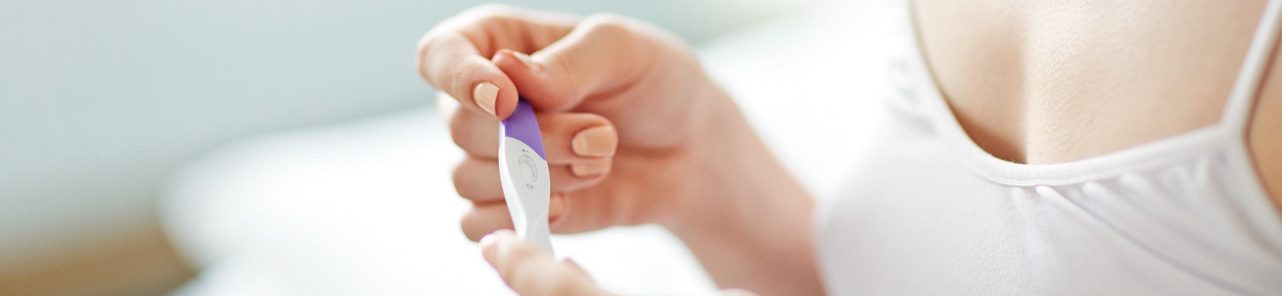 Hand holding a pregnancy test